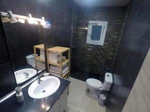 a bathroom with a sink and a toilet at YOUR HOME - Sagrada Familia Apartment in Barcelona +9 photos