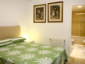 a bedroom with a bed and two pictures on the wall at Saavedra Free Parking Cordoba Center in Córdoba +17 photos