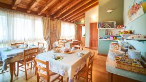 a dining room with two tables and chairs in a room at Agriturismo Roccat in Valdobbiadene