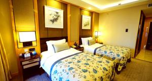 Postel nebo postele na pokoji v ubytování Beijing Yun-zen Jinling Lotus Hotel