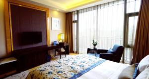 Postel nebo postele na pokoji v ubytování Beijing Yun-zen Jinling Lotus Hotel