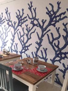 a table with plates and bowls on top at B&B Jolie in Santa Teresa Gallura