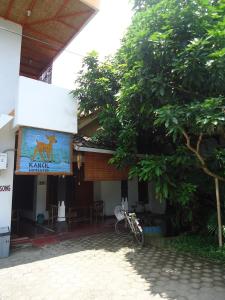 a bike parked outside of a building with a sign at Kancil homestay in Pangandaran