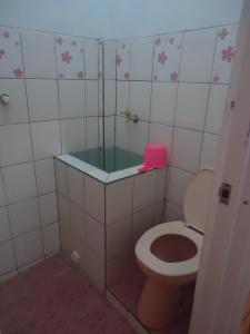 a bathroom with a toilet and a bath tub at Kancil homestay in Pangandaran