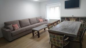 a living room with a couch and a table at Almena de San Segundo in Ávila