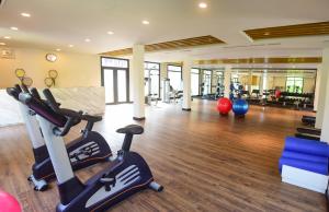 a gym with treadmills and exercise equipment in a building at Furama Villas Danang in Da Nang