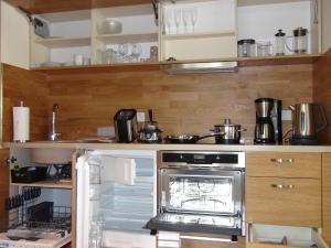 eine Küche mit einem offenen Kühlschrank und einem Herd in der Unterkunft Bio-Inn am See in Friedrichshafen