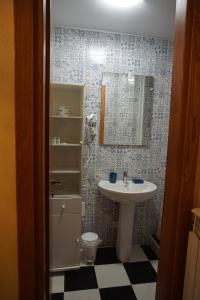 uma casa de banho com um lavatório, um WC e um espelho. em PALAZZO FULGHER em Cagliari