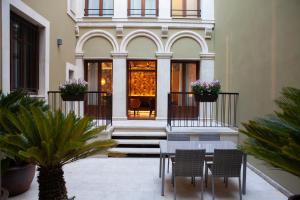 a table and chairs in front of a building at Palacete Colonial in León