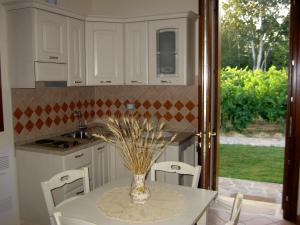 a kitchen with a table with a vase on it at Agriturismo Monteortone in Abano Terme