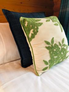 a pillow sitting on top of a bed at Redlands Country Lodge Apartments with Hot Tubs in Ladybank
