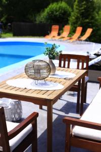 a wooden table with a bowl on it next to a pool at Marie Chalet in Breaza