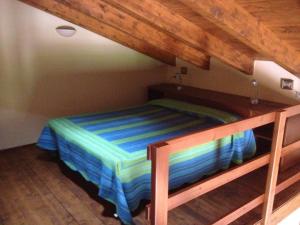 a bedroom with a bunk bed with a striped blanket at La Casa Gialla in Carloforte
