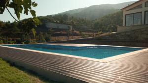 een zwembad aan de zijkant van een huis bij Casa dos Codessos in Ribeira de Pena