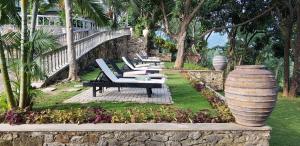 a row of lounge chairs and a large vase at Ella Planters Bungalow in Ella