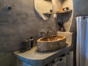 a bathroom with a wooden sink and a mirror at Windmill Arades suite in Apollonia
