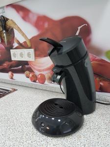 a black blender sitting on a counter with food at Apartment Alt-Refrath in Bergisch Gladbach