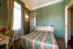 Postel nebo postele na pokoji v ubytování Hotel Villa Delle Palme