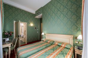 Postel nebo postele na pokoji v ubytování Hotel Villa Delle Palme
