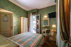 Tempat tidur dalam kamar di Hotel Villa Delle Palme