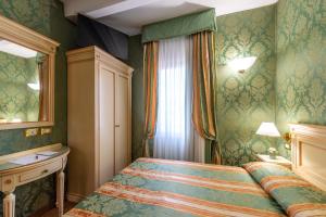 Postel nebo postele na pokoji v ubytování Hotel Villa Delle Palme