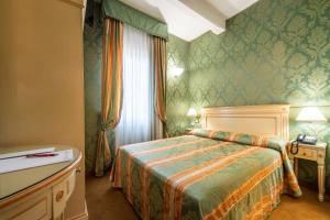 Postel nebo postele na pokoji v ubytování Hotel Villa Delle Palme