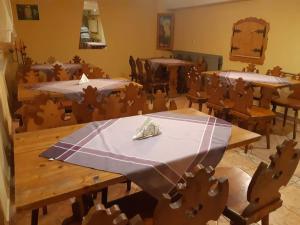 a dining room with tables and chairs with a blue table cloth at Pokoje Gościnne Skalny Agroturystyka in Żabnica