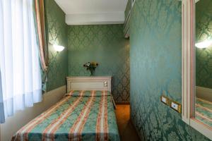 Postel nebo postele na pokoji v ubytování Hotel Villa Delle Palme