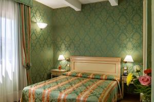 Postel nebo postele na pokoji v ubytování Hotel Villa Delle Palme