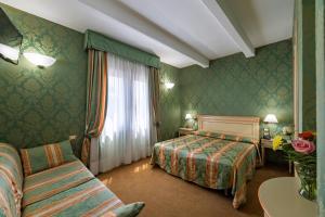 Postel nebo postele na pokoji v ubytování Hotel Villa Delle Palme