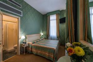 Postel nebo postele na pokoji v ubytování Hotel Villa Delle Palme