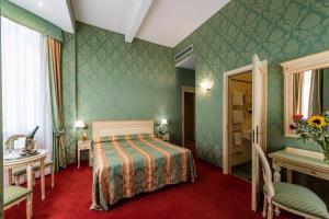 Postel nebo postele na pokoji v ubytování Hotel Villa Delle Palme