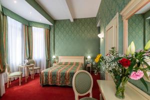Postel nebo postele na pokoji v ubytování Hotel Villa Delle Palme