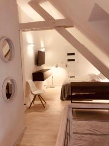 a bedroom with a bed and a chair in a room at Apartament 444 Apartamenty No.1 in Szczecin