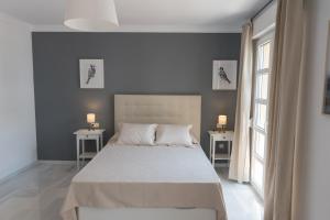 a bedroom with a bed and two tables with lamps at Apartamento Centro La Paz by CasaTuristica in Ronda