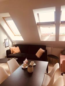 a living room with a table and a couch at Apartament 444 Apartamenty No.1 in Szczecin