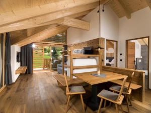 a tiny house with a loft bed and a desk at Waidacherhof Apartments in Braies