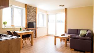 a living room with a couch and a table at Elejan in Bešeňová