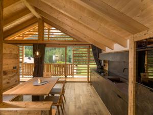 a kitchen and dining room with a wooden table in a cabin at Waidacherhof Apartments in Braies
