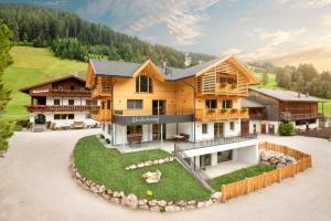 an aerial view of a house with a yard at Waidacherhof Apartments in Braies