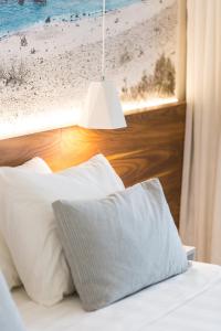 Postel nebo postele na pokoji v ubytování Atrium Ambiance Hotel
