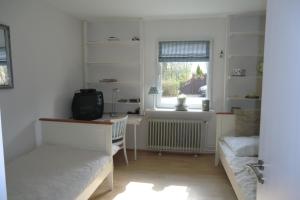 a living room with a couch and a window at Appartement Seelücke in Glücksburg