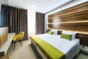 Postel nebo postele na pokoji v ubytování NB Hotel&Spa
