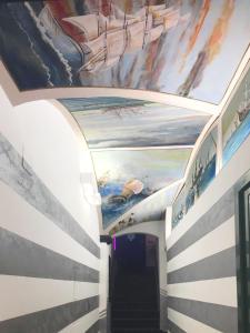 a hallway with paintings on the ceilings in a building at Torre degli Orefici dimora medioevale in Genova