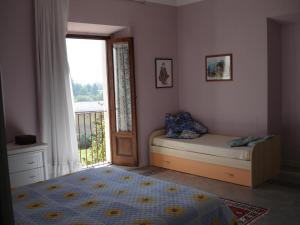 a bedroom with a bed and a window and a door at Abruzzo Segreto in Navelli