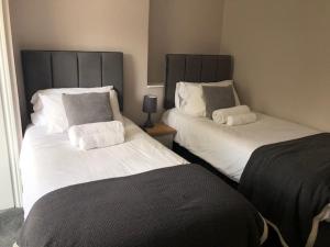 two beds sitting next to each other in a room at Prince of Wales Marlow in Marlow