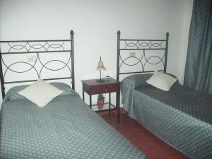 Giường trong phòng chung tại Casa rural Antonio García