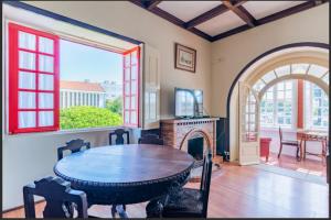a dining room with a table and a fireplace at Beach Park Guesthouse in Vila do Conde
