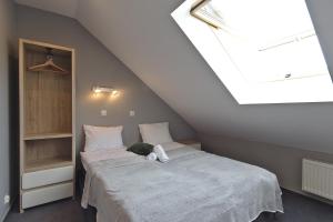 Posteľ alebo postele v izbe v ubytovaní Apartamenty Forma Tatrica