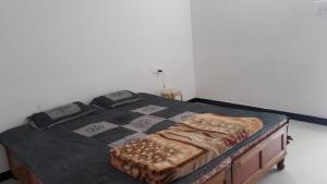 a bed in a room with a chess board on it at Tadoba Homestay Cottage in Chandrapur